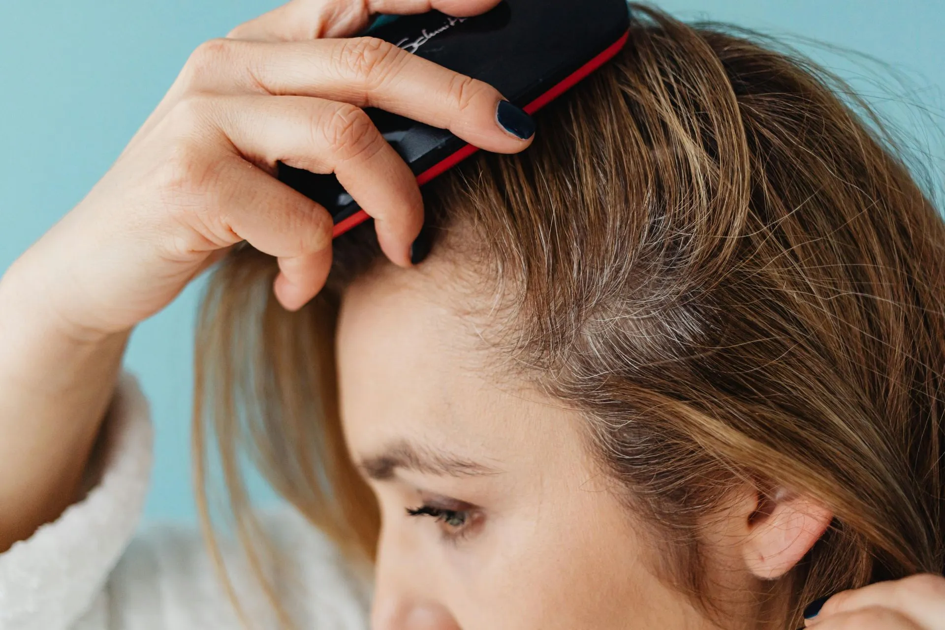 Close view of hair at the scalp during a salon treatment